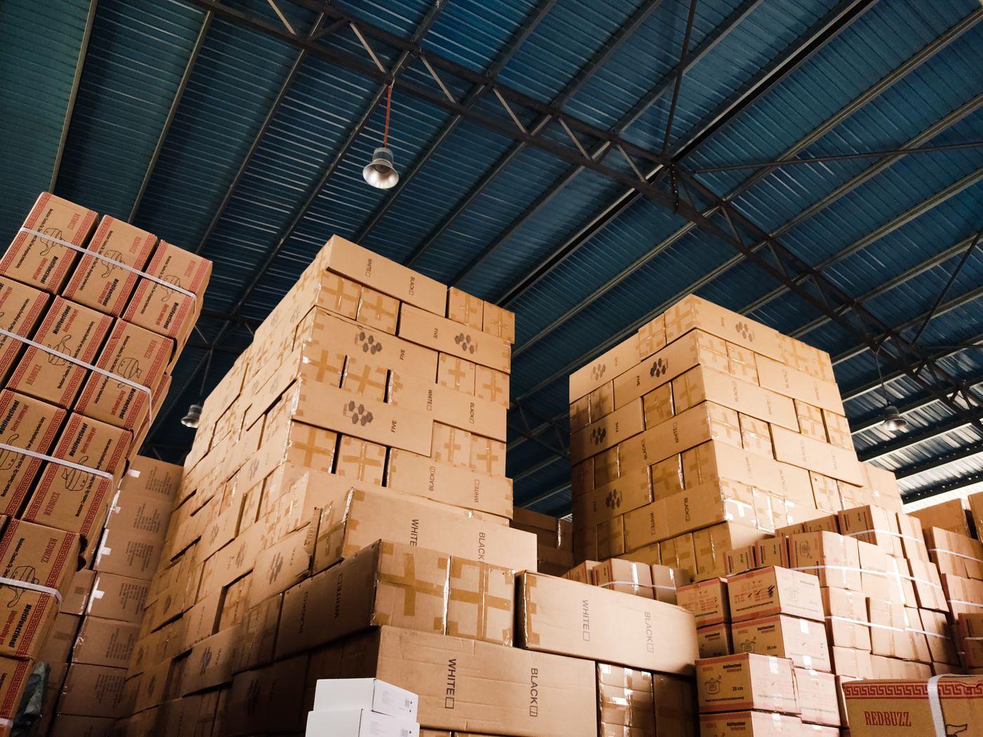 Organised stacks of sealed boxes inside a warehouse